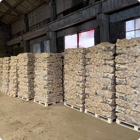 Rows of packed net-bag pallets in the Larch Wood warehouse